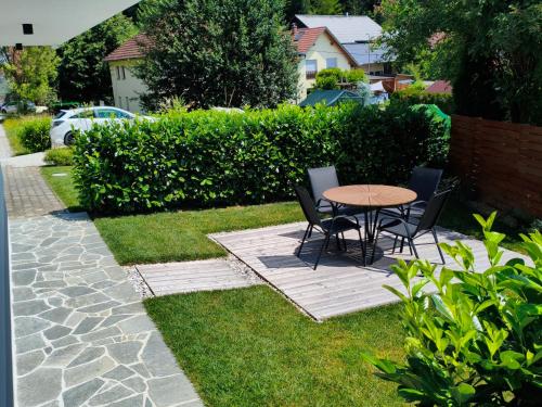 a patio with a table and chairs in a yard at Forest Hill Apartment, near Ljubljana in Dol pri Ljubljani