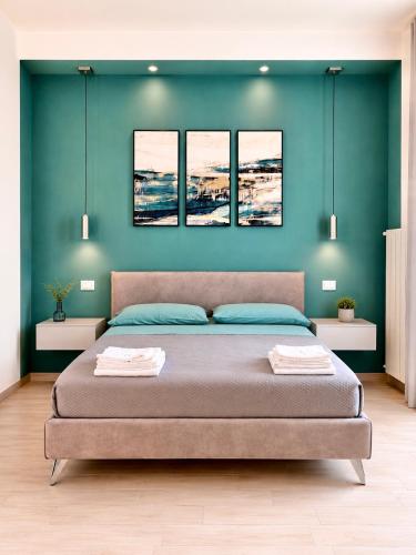 a bedroom with a bed with four pictures on the wall at Leukòs Bed and Breakfast in Castelsaraceno