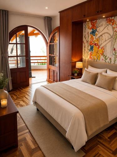 a bedroom with a large bed with a painting on the wall at Rolys House in Los Baños del Inca