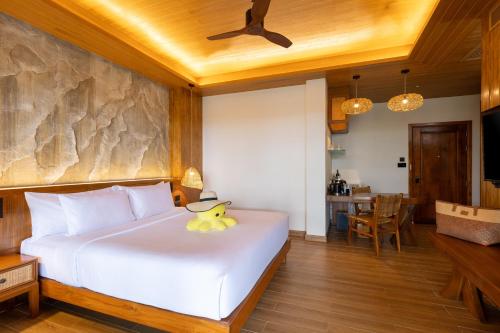 a bedroom with a bed with a duck toy on it at SINAE Phuket Luxury Hotel in Phuket