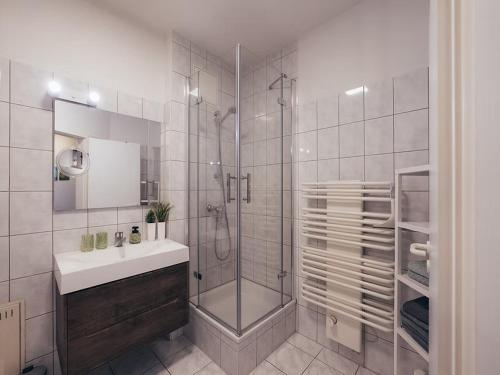 a white bathroom with a shower and a sink at Apartment Hainich in Mühlhausen