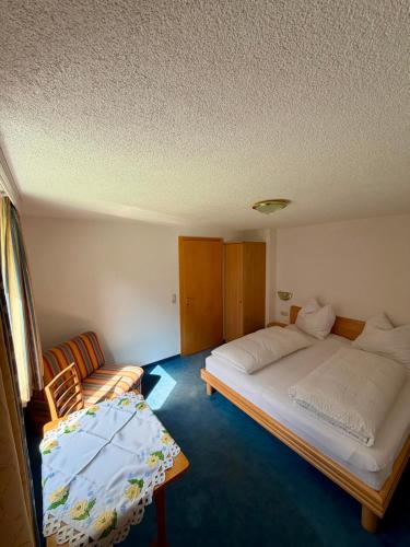 a room with two beds and a couch in it at Haus Leo in Kappl