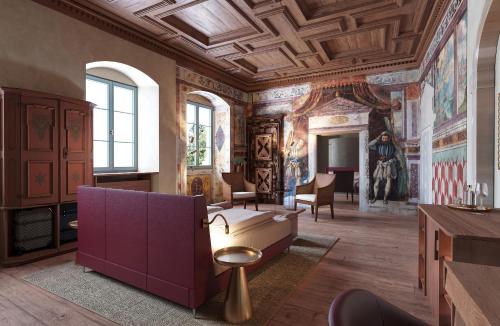 a large room with paintings on the ceilings at Langenmantel Historic Suites in Termeno