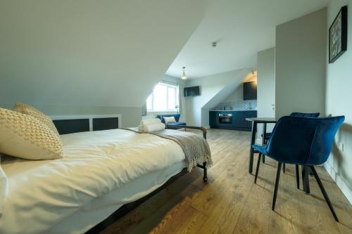 a bedroom with a bed and a table and chairs at The Willow Apartments in Bristol
