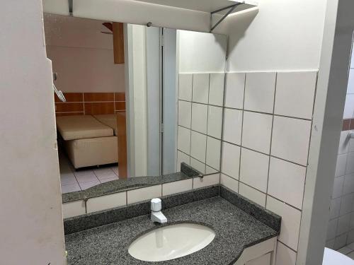 a bathroom with a sink and a mirror at CRCN - Aquarius Flat in Caldas Novas
