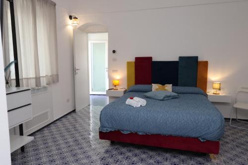 a bedroom with a bed and a flat screen tv at Maison Gadì in Maiori