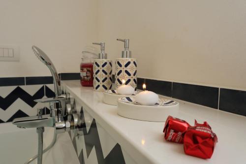 a bathroom counter with two candles and presents on it at Maison Gadì in Maiori