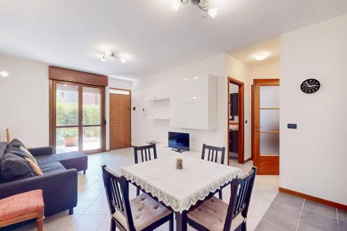 a living room with a table and a couch at [BuenRetiro] Giardino, box e bici a disposizione in Acqui Terme