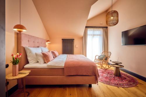 a bedroom with a large bed and a window at Hotel Lahneck in Nievern