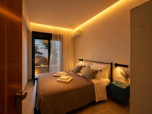 a bedroom with a large bed with a window at ELÉNAS slow living villa in Faliraki