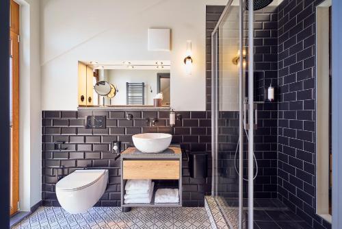 a bathroom with a sink and a toilet and a mirror at Hotel Lahneck in Nievern