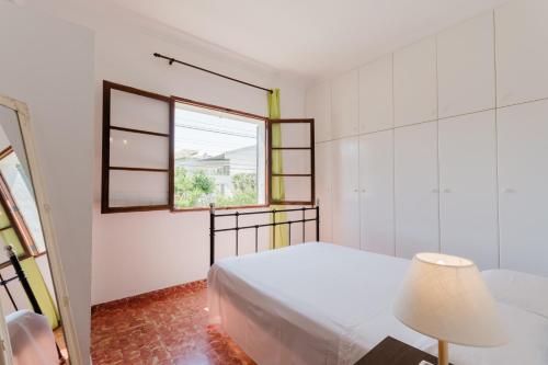 a bedroom with a bed and a window at Holiday Home Kety in Portals Nous