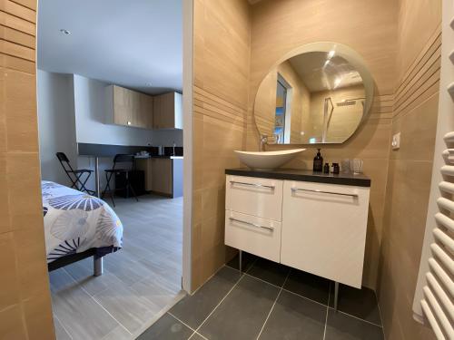 a bathroom with a sink and a mirror at Entre Mer Et Pinède Piscine in Bandol