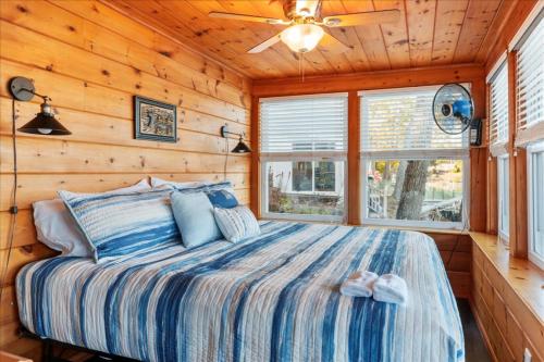 a bedroom with a bed in a log cabin at Waterfront w/ Prvt Dock & Firepit | Sleeps 8 in Acton