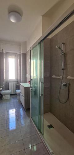 a large bathroom with a shower and a toilet at Miramare Apartment in Ancona