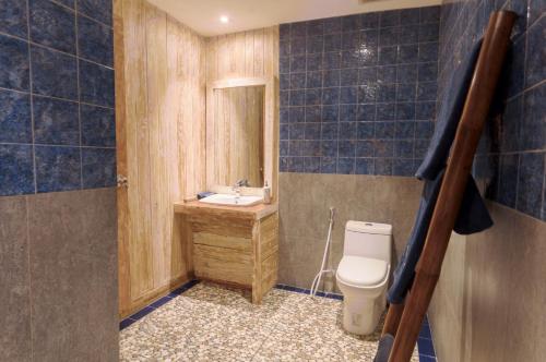 a bathroom with a toilet and a sink at Maresia in Gili Islands