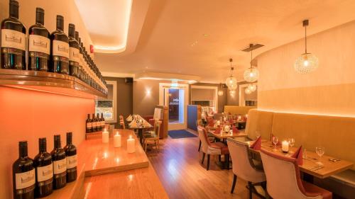 a restaurant with tables and wine bottles on the wall at Clew Bay Hotel in Westport