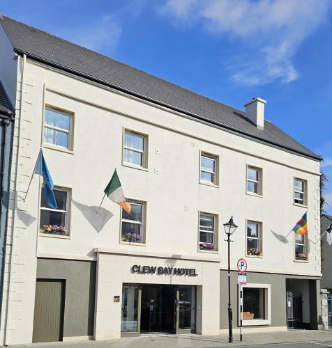 a large white building with flags on it at Clew Bay Hotel in Westport