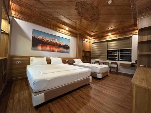a large bedroom with two beds and a fireplace at Khách Sạn Ka Long in Móng Cái