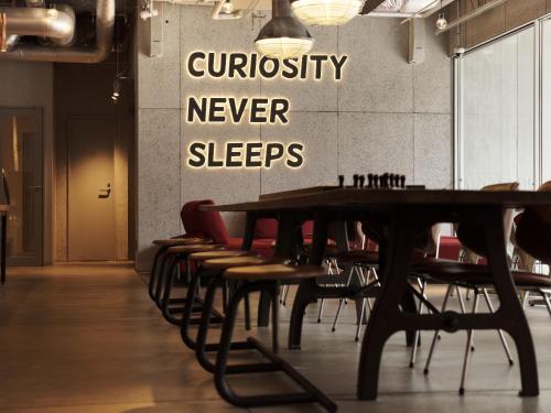 a conference room with a wooden table and chairs at ONE@Tokyo by insomnia in Tokyo