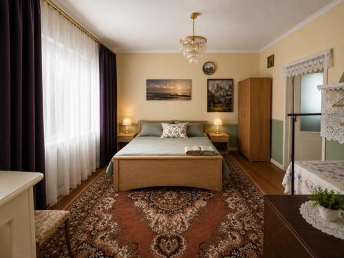 a bedroom with a bed and a large window at Nad stawem dom in Pietkowo