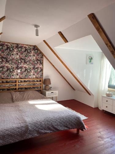 a bedroom with a bed with a floral wall at East Mountain Villa - Private Nature Retreat in Baranja in Batina