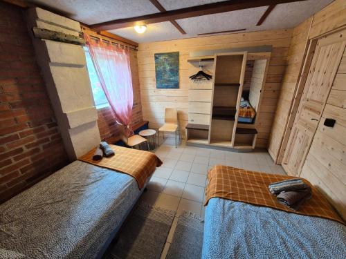 a small room with two beds in a room at Rusnietis in Rusnė