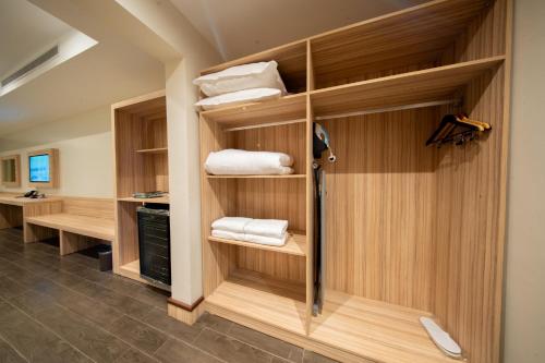 a bathroom with wooden walls and shelves with towels at Continent Al Marzam in Medina