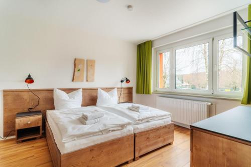 ein Schlafzimmer mit einem großen Bett und einem großen Fenster in der Unterkunft Bodeapartment 4 in Elend