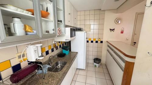 a small kitchen with a sink and a refrigerator at CRCN - Eldorado Thermas Park in Caldas Novas