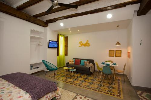 a bedroom with a bed and a couch and a table at Eco-Friendly Apartments in Valencia