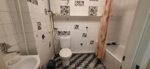 a small bathroom with a toilet and a sink at Pokoje u Irenki in Augustów