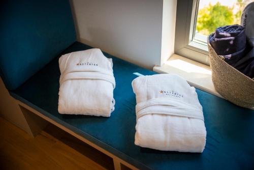 two white towels sitting on a table next to a window at Asterias Residence - New Opening 2026 in Rovinj