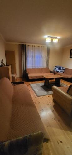 a living room with a couch and a table at Pokoje u Irenki in Augustów