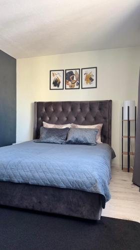 a bedroom with a large bed with a large headboard at TEATRA Apartamenti in Liepāja