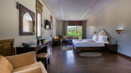 a hotel room with a bed and a living room at Dar Zayane in Khenifra