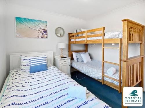 a bedroom with two bunk beds and a bed at Town & Tide, Cowes Central in Cowes