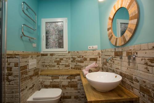 a bathroom with a sink and a toilet and a mirror at Eco-Friendly Apartments in Valencia