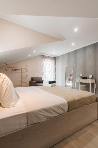 a bedroom with a large bed and a desk at Angelikis Maisonette in Kastoria