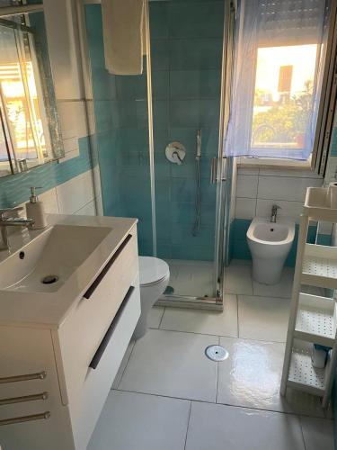 a bathroom with a shower and a sink and a toilet at A casa mia in Gaeta