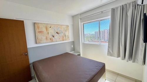 a small room with a bed and a window at CRCN - Evian Thermas Residence in Caldas Novas