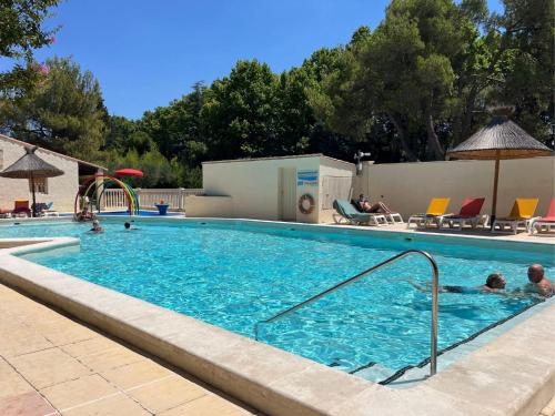 a large swimming pool with people in it at Camping Pegomas in Saint-Rémy-de-Provence
