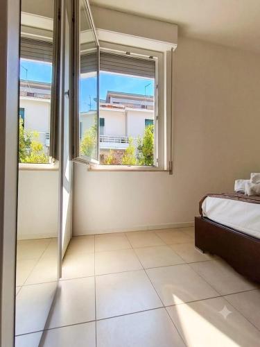 a bedroom with a bed and two windows at Free Parking a 100 mt dal mare-Wave HuoSe in Pesaro