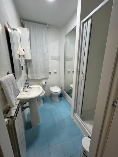 a bathroom with a sink and a toilet and a shower at Pellegrino House in Palermo