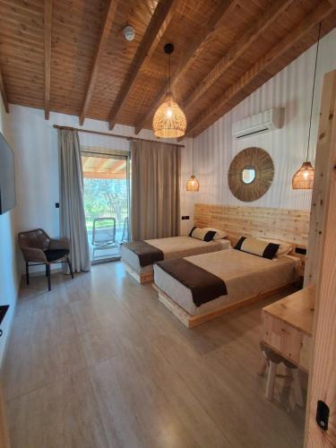 a large bedroom with two beds and a table at Simos Magic Beach Hotel Apts in Ayia Napa