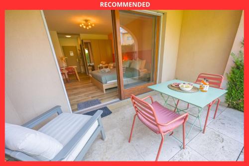 a patio with a table and two chairs and a table and a table at Spa Thermal, Design, Terrasse in Saillon