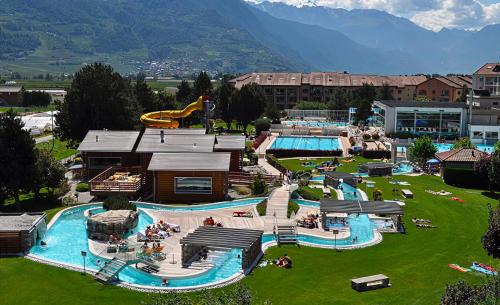 an outdoor water park with a large pool and slides at Spa Thermal, Design, Terrasse in Saillon