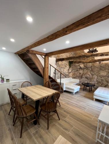 a living room with a wooden table and chairs at Pr'Tončih in Podgorje