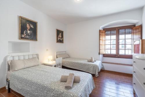 a living room with two beds and a window at Between sea and Altafulla castle in Altafulla