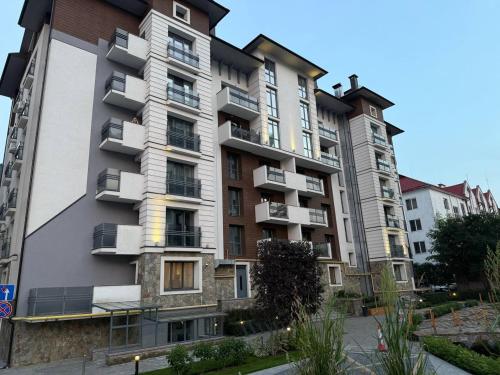a tall apartment building with balconies on it at ''Панорама Карпат'' Апартаменти в чудовому місті Яремче in Yaremche